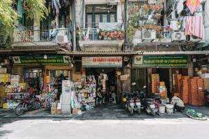 a building with a bunch of shops in a street at An Family Homestay in Hanoi