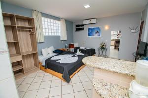 a hotel room with a bed and a bathroom at Residencial BoaVida in Fortaleza