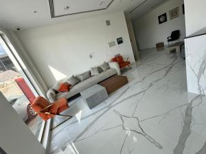 a living room with a couch and a marble floor at السمو ALSMOU للشقق الفندقية in Nizwa