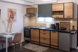 uma cozinha com armários de madeira e uma bancada em Niki Athens Suites - Urban apartment in Athens Center em Atenas