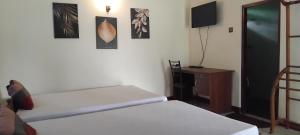 Ένα ή περισσότερα κρεβάτια σε δωμάτιο στο Hansika Guest Inn