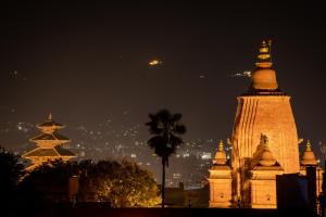 a group of pagodas and a city at night at The Muglan Hotel and Restaurant in Bhaktapur