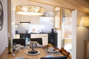 a kitchen with a table and a dining room at Chasa Bagnera 174 in Scuol