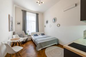 a bedroom with a bed and a couch and a table at Awesome Stay Studios in Prague