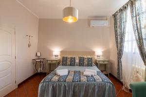 a bedroom with a bed with two towels on it at Il Torrione in Castiglione del Lago