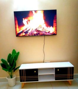 a flat screen tv hanging on a wall at T Tree Paradise Apartments Embu in Embu