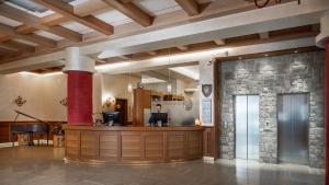 a lobby with a hair salon with a stone wall at 5Miglia Hotel & Spa in Rivisondoli