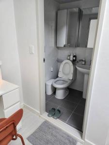 a small bathroom with a toilet and a sink at Suwon station City House in Suwon