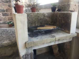 a stone fireplace with some wood on it at Casetta delle anfore in Alliste