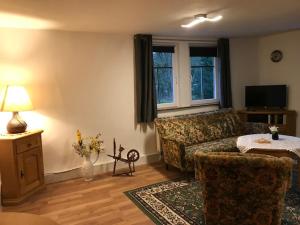 a living room with a couch and a table at Gästehaus Reimold in Bebra