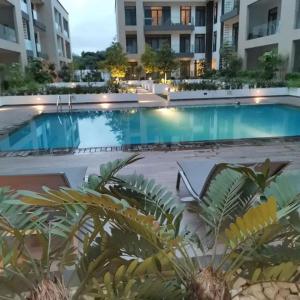 a large swimming pool in front of a building at The VVIP Luxury Apartments @ Gardens in Accra