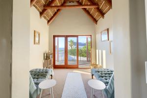 a living room with two chairs and a table at Moana Bay in Kommetjie