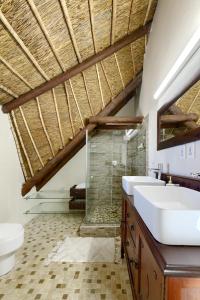 a bathroom with two sinks and a toilet at Moana Bay in Kommetjie