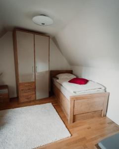 a bedroom with a bed and a cabinet and a rug at Retreat am See in Leipzig