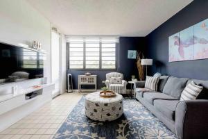 a living room with a couch and a table at Carey Beach Villa in Humacao