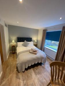 a bedroom with a large bed and a window at Stylish apartment, Taunton in Taunton