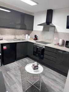 a kitchen with a table with a cake on it at 2Bed flat In Leicester ! in Leicester