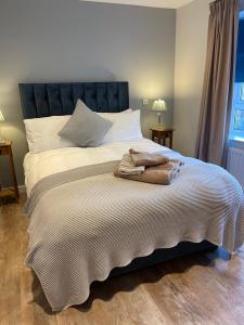 a large bed with two towels on top of it at Stylish apartment, Taunton in Taunton