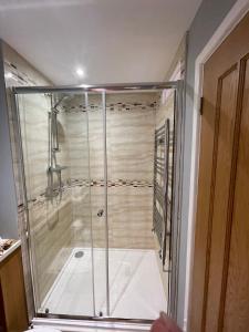 a shower with a glass enclosure in a bathroom at Stylish apartment, Taunton in Taunton