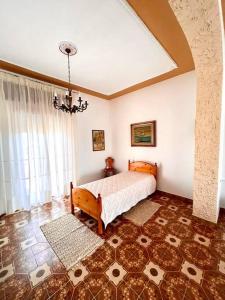 a bedroom with a bed and a large window at Casa Leonarda in Olmedo