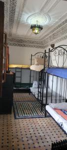a room with two bunk beds and a ceiling at Riad El Blida in Fez
