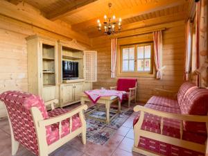 ein Wohnzimmer mit einem Tisch und Stühlen in einer Hütte in der Unterkunft 1A Chalet Koralpenzauber - Wandern, Sauna, Grillen mit Traumblick in Wolfsberg