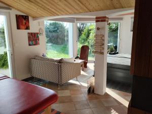 a living room with a table and chairs and a window at L'eden naturiste spas in Challans