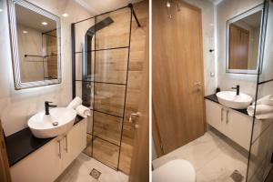 Un baño con dos lavabos y una ducha de cristal. en Beachfront Villa Kyma - Your own Private paradise, en Kalí Limenes 24 fotos más