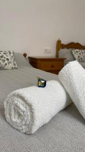 a white blanket on top of a bed at Casa rural completa y con garaje in Vigo