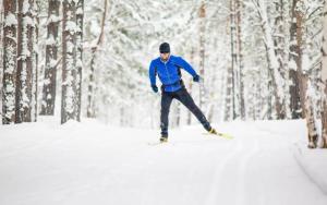 a man is skiing in the snow in the woods at Horská chata KRKONOŠKA HARRACHOV in Harrachov