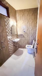 a bathroom with a toilet and a sink at Govind puri residency in New Delhi