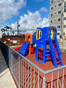 a playground with a play set on a fence at Apartamento em Ponta de Campina in Cabedelo