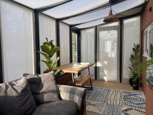 a living room with a couch and a table at Beautifully appointed one-bedroom cottage in Shepreth