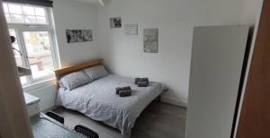 a small bedroom with a bed and a window at Double Room No,4 Edmonton Green, London N9 in London
