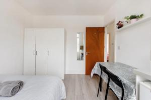 a white bedroom with a bed and a table at Double Room No,4 Edmonton Green, London N9 in London