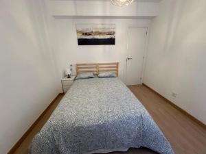 a bedroom with a large bed in a white room at Urbsvetus 2 in Oviedo