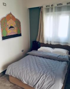 Postel nebo postele na pokoji v ubytování Maadi Groove Guesthouse