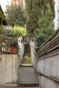 un callejón con escaleras y plantas al lado de un edificio en Cozy house at Vatican/StPeter's dome shade., en Roma