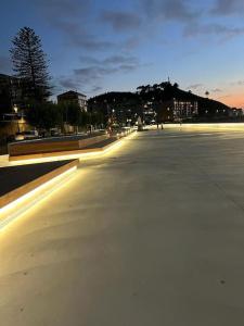 an empty street at night with buildings in the background at Recuncho Costeiro in Baiona