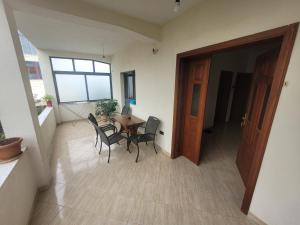 a dining room with a table and chairs in a room at Garden house in Kashari +6 photos