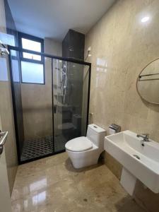 a bathroom with a shower and a toilet and a sink at IPOH Tambun the cove your ultimate relaxing gateaway 111 in Ipoh
