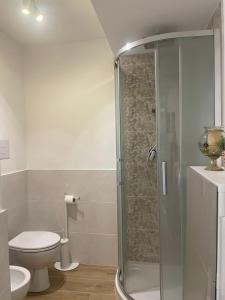 uma casa de banho com um WC e uma cabina de duche em vidro. em CAIROLI14 em Brescia
