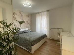 a bedroom with a bed and a plant in it at CAIROLI14 in Brescia