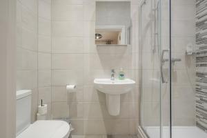 a bathroom with a sink and a toilet and a shower at Belfast City Centre - 3 bed, 3 bathroom & parking by StayByNumbers in Belfast