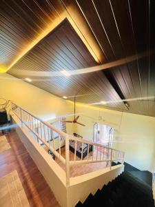 a room with a wooden ceiling with a table in it at Jhelum Villa by Sharayu Holidays in Panchgani