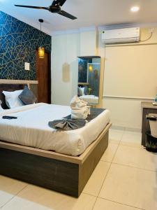 a bedroom with a bed and a mirror in it at Hotel Blue Petals in Shamshabad