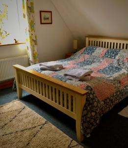 a bedroom with a bed with a quilt on it at Little Glebe in Sherborne