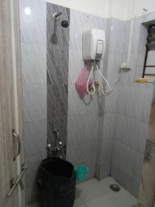 a bathroom with a shower with a toilet in it at Om Sai Guest House in Nashik