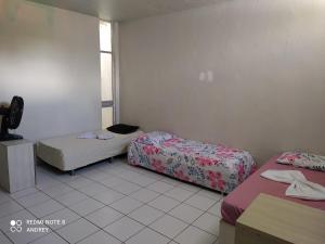 a room with two beds and a window at Marbelo Pernambuco in Recife
