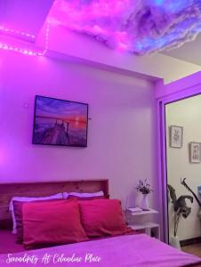 a bedroom with a bed with a purple ceiling at SERENDIPITY PLACE @CELANDINE in Manila